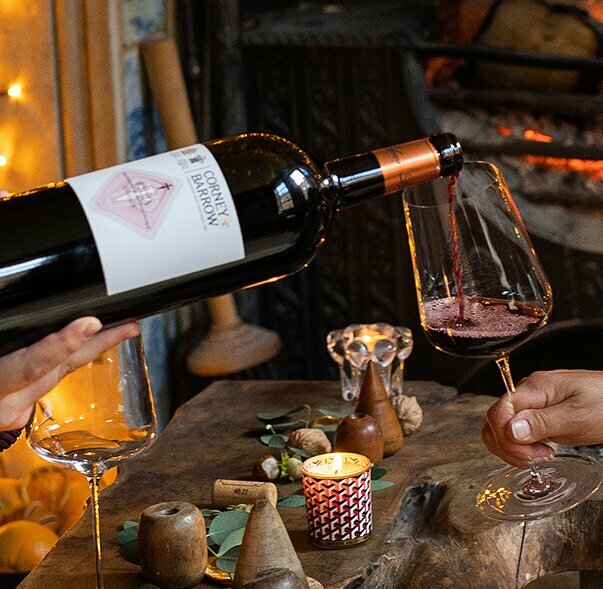 FIREPLACE, MAGNUM POURING WINE INTO GLASS