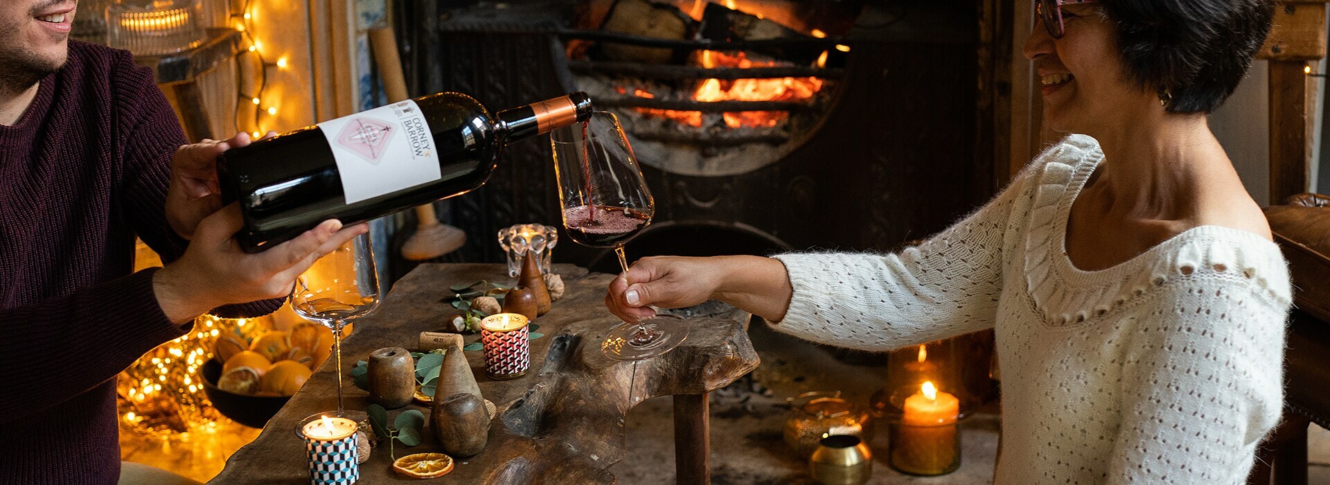 FIREPLACE, MAGNUM POURING WINE INTO GLASS